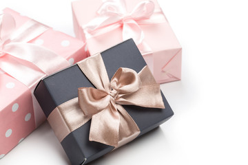 Luxury boxes tied with a pink and gold ribbon.
