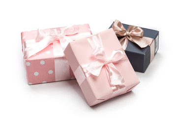 Luxury boxes tied with a pink and gold ribbon.