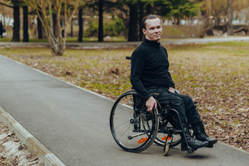 Portrait of a happy man on a wheelchair in a park