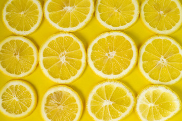 A slices of fresh juicy yellow lemons. Texture background, pattern