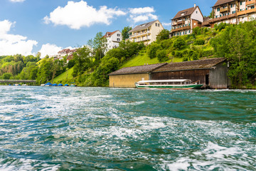 Beautiful view of the Rhine river in turquoise, at the source in Switzerland, just behind the biggest waterfall in Europe.