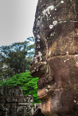 Close-up of stone face with forest in background, Angkor, Siem Reap, Combo