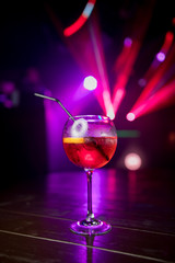 Sweet Famous aperol spritz champagne orange slice Author inspired Cocktail Drink on bar counter. Close-up Top view near girl . Copy paste space for design people and luxury service barman in nightclub