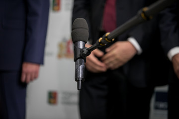 Fototapeta premium Media interview - group of journalists surrounding VIP