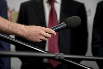Media interview - group of journalists surrounding VIP