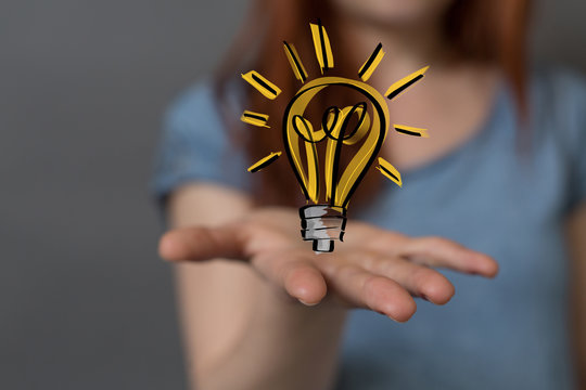  holding illuminated light bulb, idea, innovation and inspiration concept.