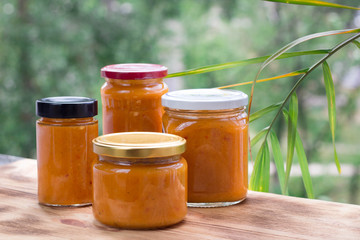 Composition of apricot jam cans prepared from berry summer harvest