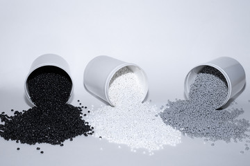 Glass with termoplastic elastomer granules on a white background