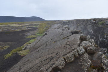 Landscape with many lava craters at grotto Grotagja Cave in Myvatn, Iceland 