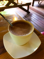 Hot chocolate or cocoa drink in a cup.On the table in coffee shop
