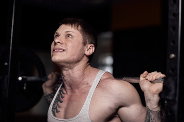 close up.a confident bodybuilder working with a barbell.