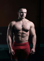 Fototapeta na wymiar portrait of handsome male bodybuilder isolated on black background