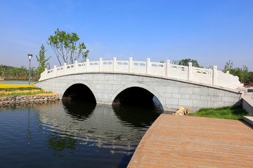 Double arch stone bridge and wooden platform