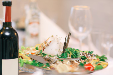 close up.a bottle of wine and a snack on the festive table