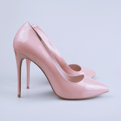 female pink shoes on gray background