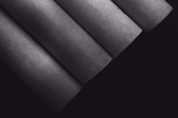 Abstract background, cylindrical gray elements on black
