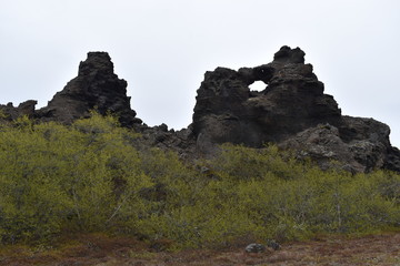 Big hole in the rock at lava field Dimmu Borgir in Myvatn, Iceland