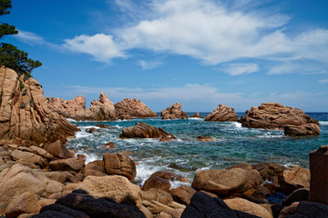 Stunning red rock formation at beach with turquoise blue sea at La Sorgente, Costa Paradiso in Sardinia (Italy) 