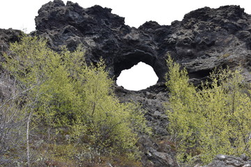 Big hole in the rock at lava field Dimmu Borgir in Myvatn, Iceland