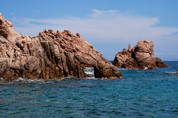 Rugged rock formation at a turquoise beach at La Sorgente, Costa Paradiso in Sardinia (Italy) with turquoise blue sea