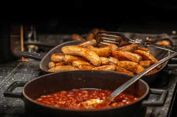 Grilled sausages in iron pan