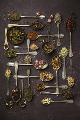 Assortment of dry tea in vintage spoons