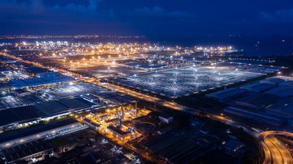 aerial view factory zone and shipping port on the sea at night