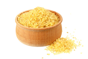 dry bulgur wheat in wooden bowl isolated on white background. top view