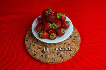 a series of calorie foods strawberries 41 kcal per 100 grams on a black background