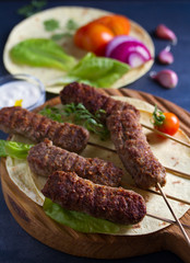 Kofta kebabs with pita bread, vegetables and yogurt sauce