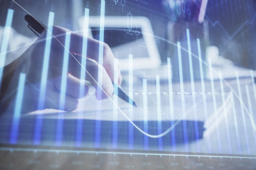 Financial charts displayed on woman's hand taking notes background. Concept of research. Double exposure