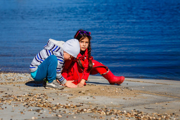 Little children play by the sea