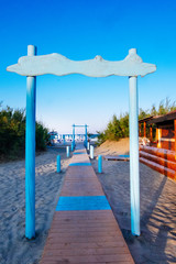 wooden decking for the road to the sea, on the beach near the beach bar. arch at the entrance to the sea