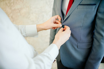 groom in a jacket, the groom fastens his jacket, The morning of the groom, bridegroom's fees