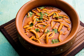 Dhaba style Sev bhaji/sabzi/curry made in tomato curry with gathiya shev, served in a bowl or karahi, selective focus