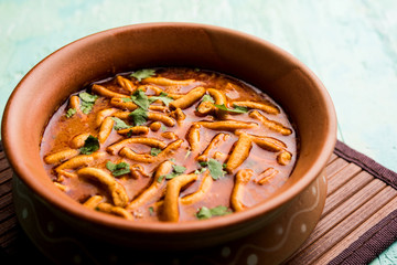 Dhaba style Sev bhaji/sabzi/curry made in tomato curry with gathiya shev, served in a bowl or karahi, selective focus