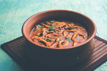 Dhaba style Sev bhaji/sabzi/curry made in tomato curry with gathiya shev, served in a bowl or karahi, selective focus