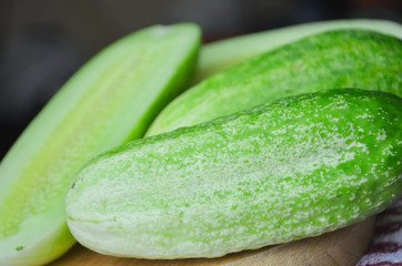 Cucumber sliced on the cutting board, salad ingredient, fresh cucumbers on a table.