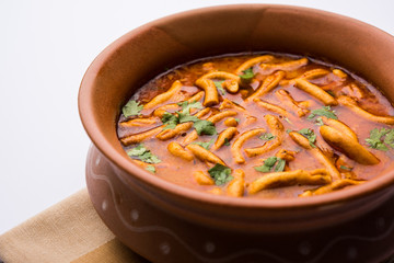 Dhaba style Sev bhaji/sabzi/curry made in tomato curry with gathiya shev, served in a bowl or karahi, selective focus