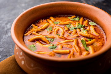 Dhaba style Sev bhaji/sabzi/curry made in tomato curry with gathiya shev, served in a bowl or karahi, selective focus