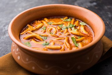 Dhaba style Sev bhaji/sabzi/curry made in tomato curry with gathiya shev, served in a bowl or karahi, selective focus