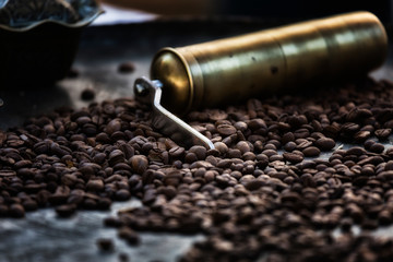 Coffee grains and manual coffee grinder. Selective focus