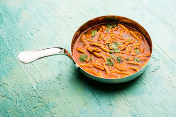 Dhaba style Sev bhaji/sabzi/curry made in tomato curry with gathiya shev, served in a bowl or karahi, selective focus