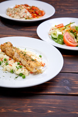 chicken kebab with rice and vegetables on the wooden background