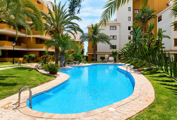 Idyllic place for vacationers residential high rise building house with swimming pool closed urbanization area green lawn for relaxation, Punta Prima, Torrevieja, Spain