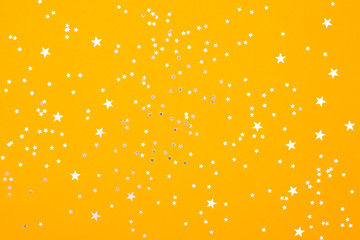 Obraz na płótnie Canvas White stars on yellow bright background. Festive backdrop