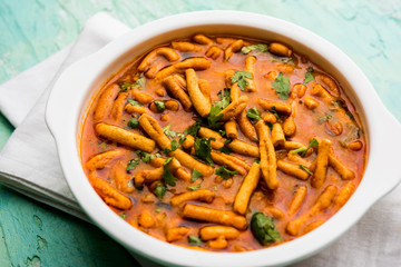 Dhaba style Sev bhaji/sabzi/curry made in tomato curry with gathiya shev, served in a bowl or karahi, selective focus
