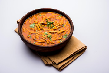Dhaba style Sev bhaji/sabzi/curry made in tomato curry with gathiya shev, served in a bowl or karahi, selective focus