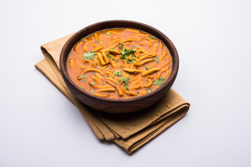 Dhaba style Sev bhaji/sabzi/curry made in tomato curry with gathiya shev, served in a bowl or karahi, selective focus
