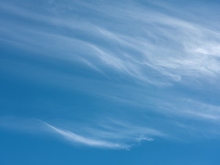 Blue sky with white clouds close up in the summertime